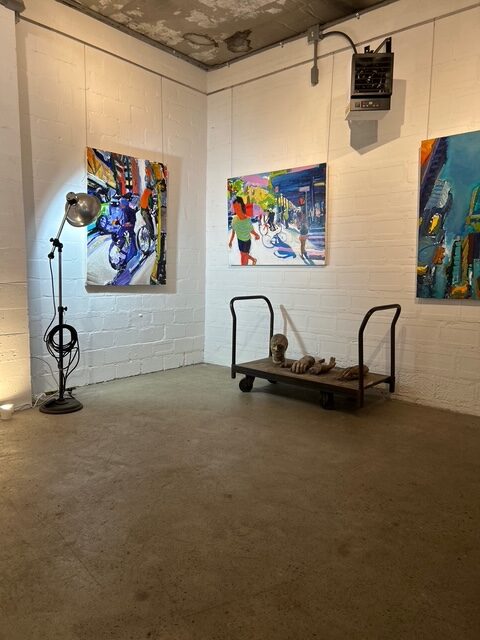 Tom Christopher paintings alongside foundry crucible, studio showroom, Lift Trucks Art